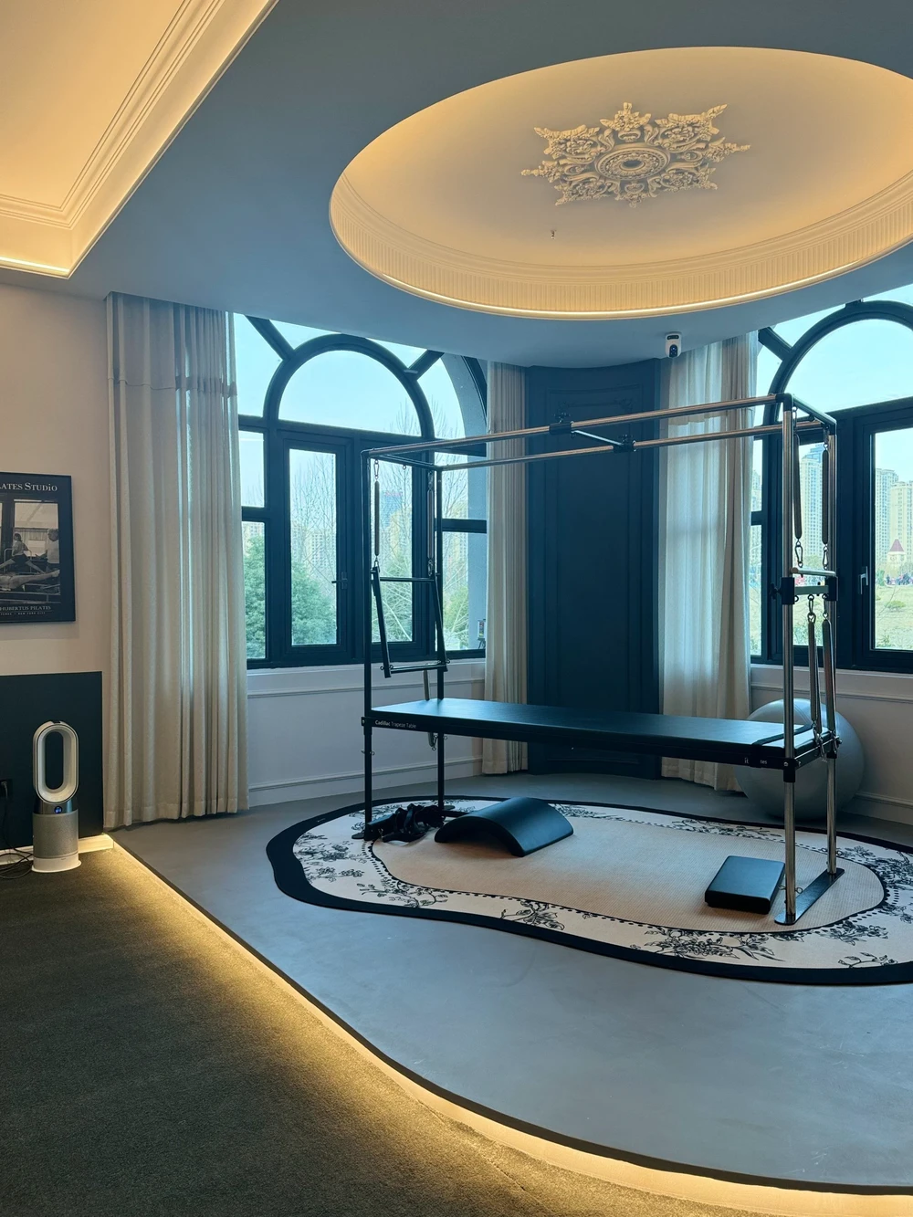 A minimalist Pilates studio with multiple Reformers