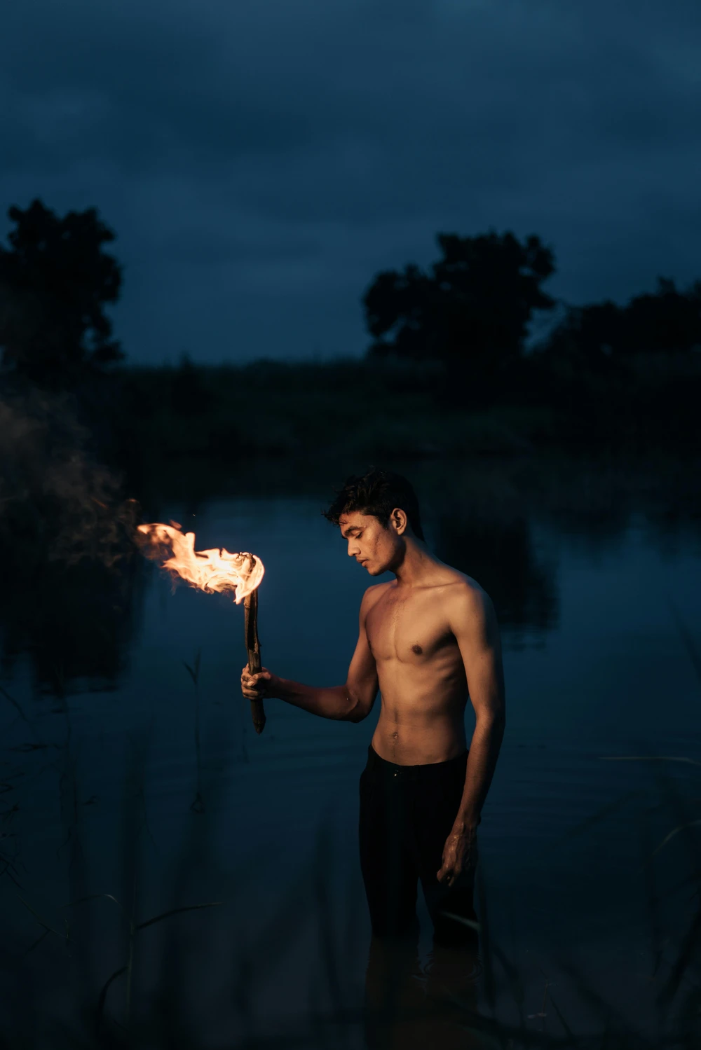 A person standing on a mountain peak at sunrise, arms raised in victory, demonstrating physical and mental triumph over nature's challenges
